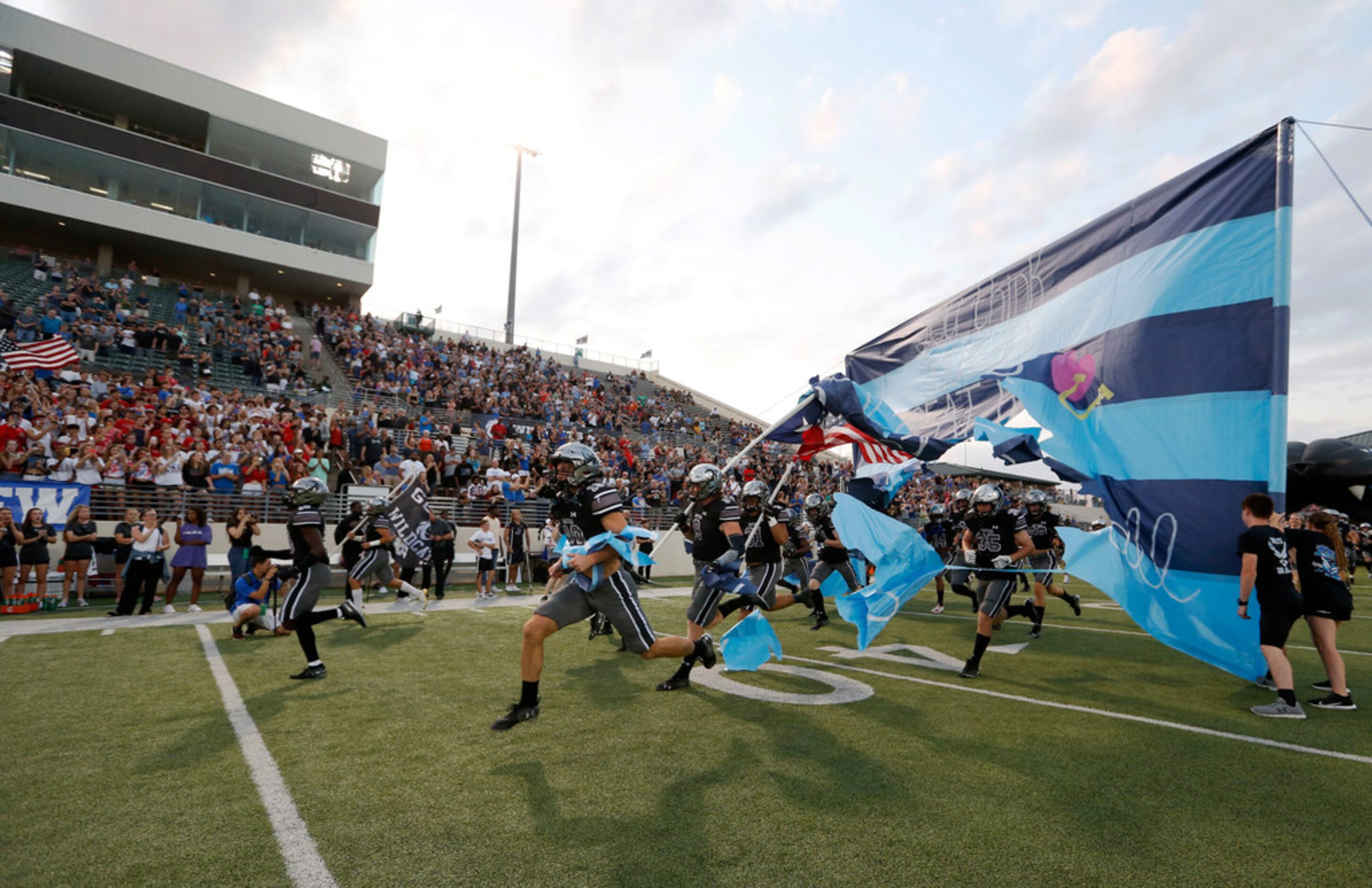 Denton Guyer takes the football field during introductions before a football game against...