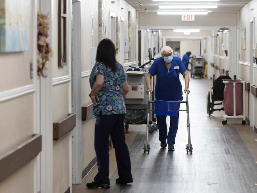 Nurses walk in the hallway outside of resident’s rooms at Focused Care at Waxahachie in...
