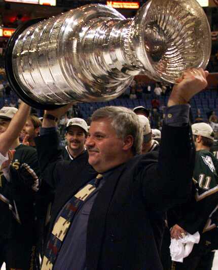Dallas Stars coach Ken Hitchcock hoists the Stanley Cup after the Stars defeated the Buffalo...
