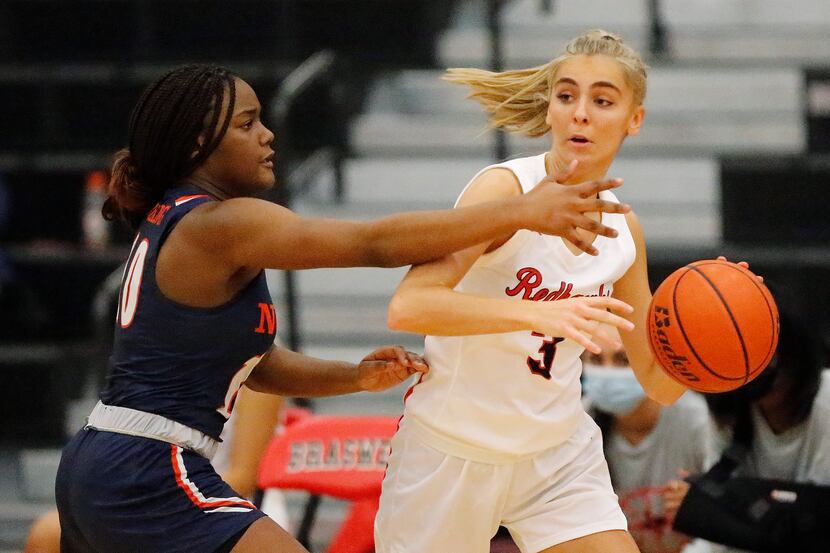 Frisco Liberty High School guard Lily Ziemkiewicz (3) looks to pass while defended by...
