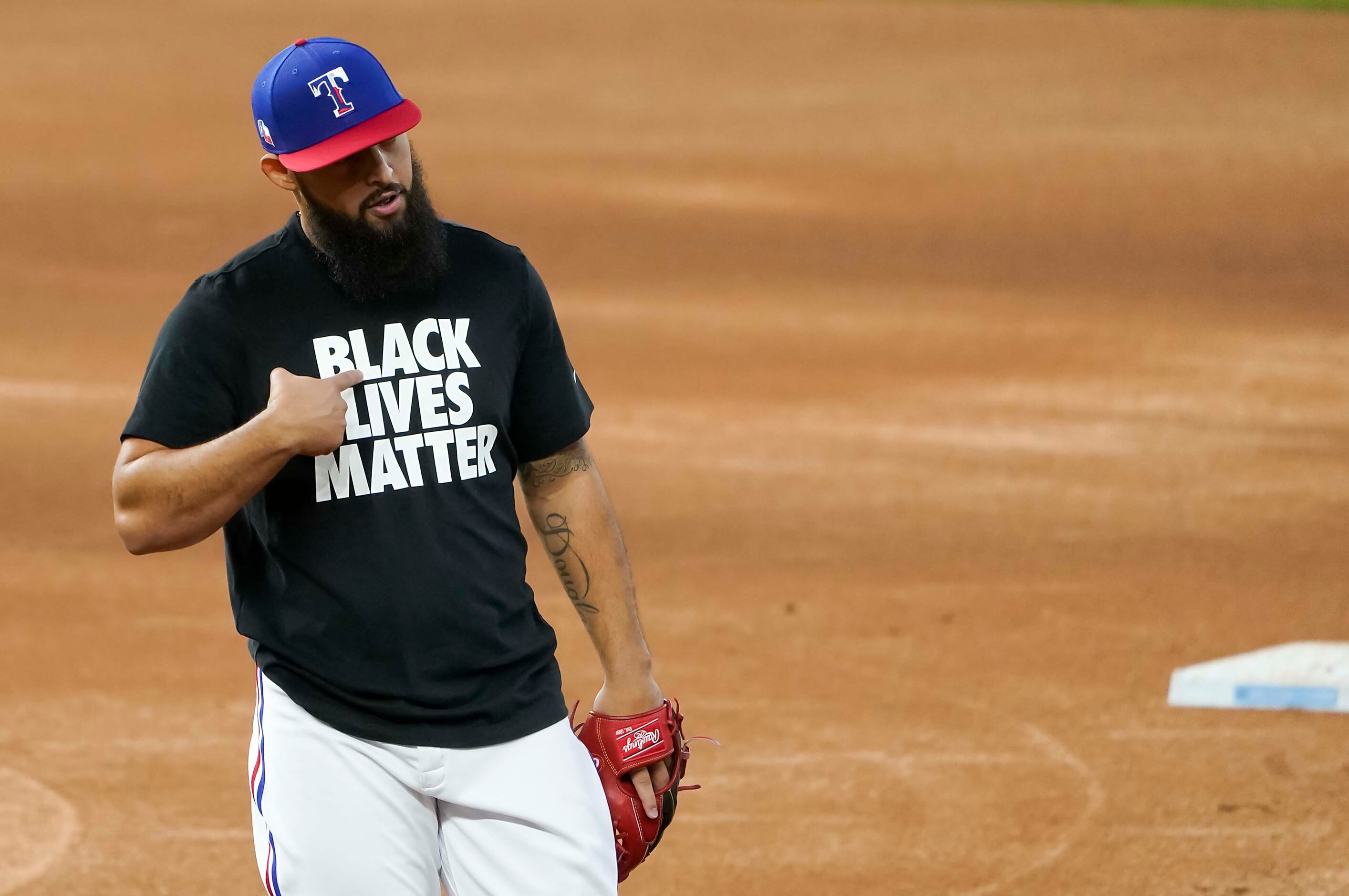 Texas Rangers second baseman Rougned Odor points to his t-shirt reading Black Lives Matter...