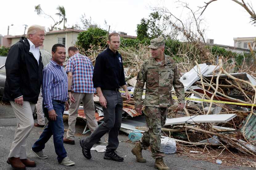 President Donald Trump walks with FEMA administrator Brock Long, second from right, and Lt....