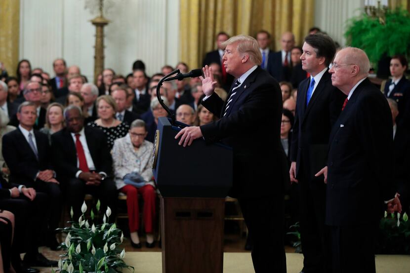 President Donald Trump, with Justice Brett Kavanaugh and retired Justice Anthony Kennedy,...