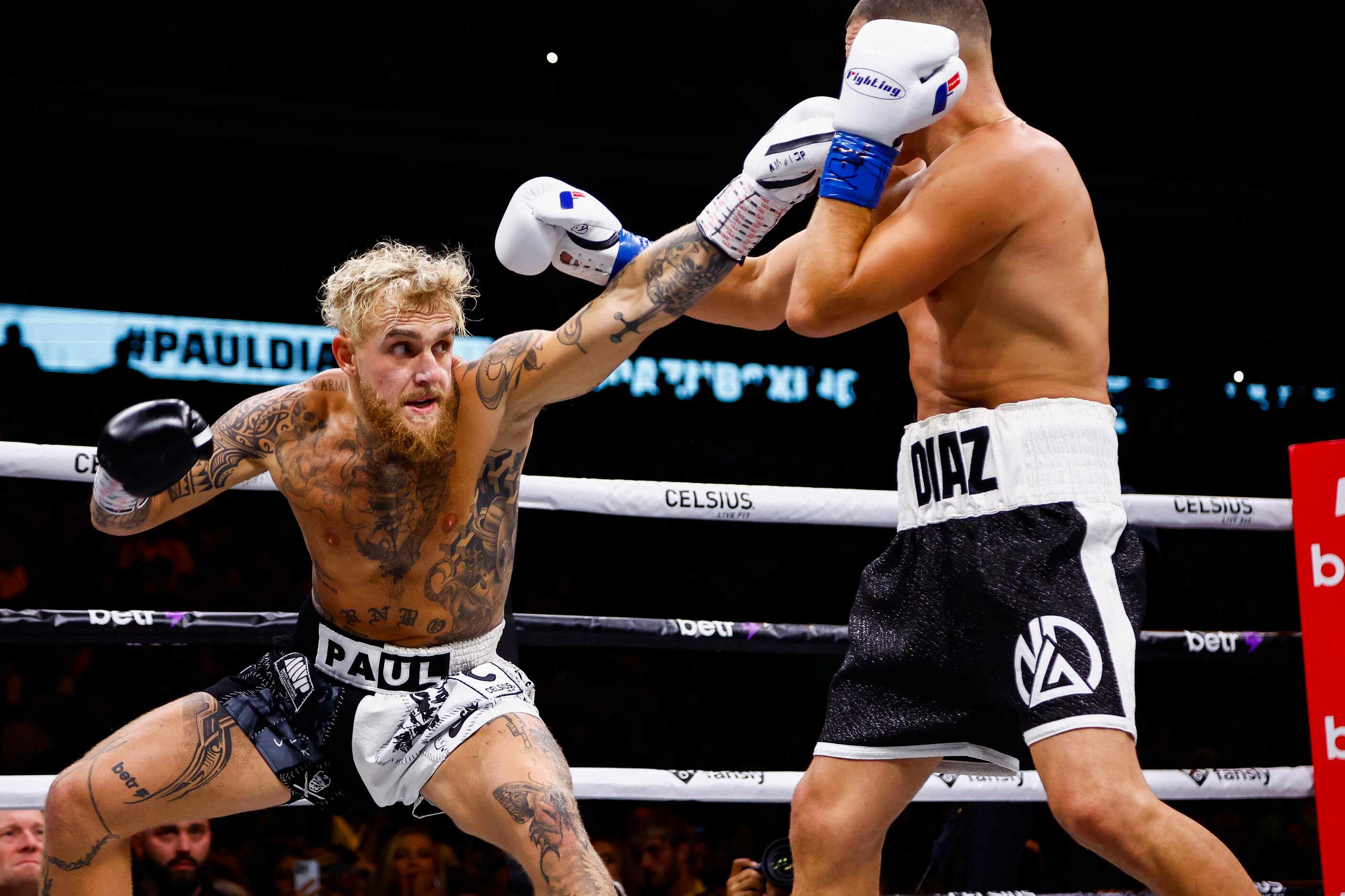Jake Paul, left, lands a punch on Nate Diaz during a boxing match in Dallas, Saturday,...
