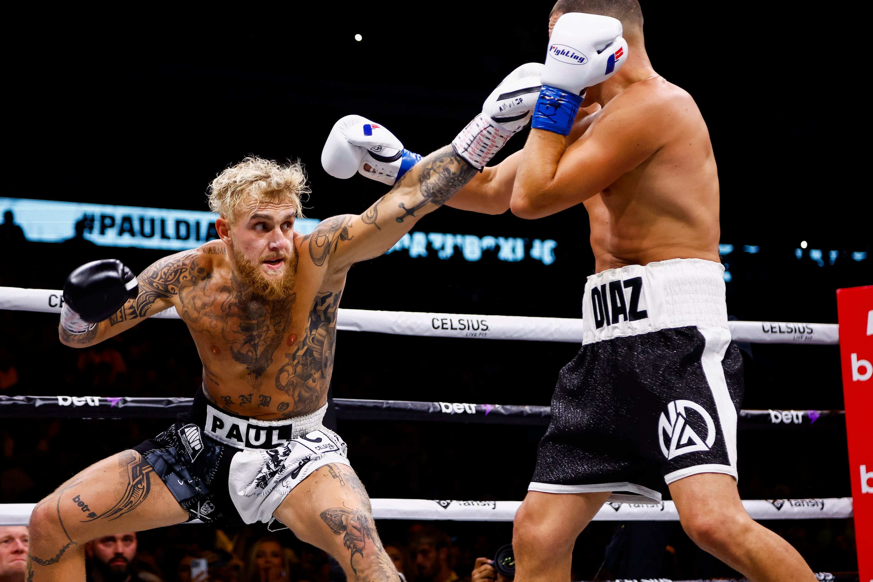 Jake Paul, left, lands a punch on Nate Diaz during a boxing match in Dallas, Saturday,...