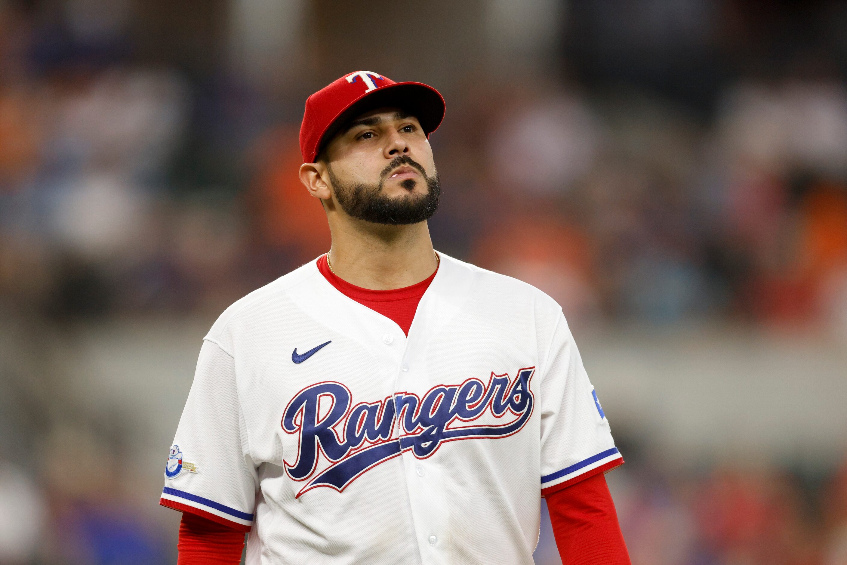 Texas Rangers starting pitcher Martin Perez (54) walks off the field after the top of the...