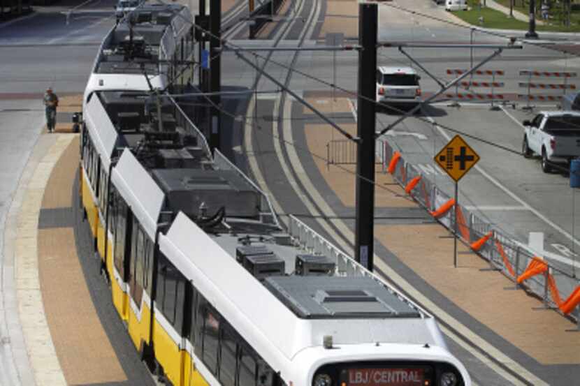 The new DART Orange Line train crosses O'Connor Blvd as it approaches the Las Colinas Urban...