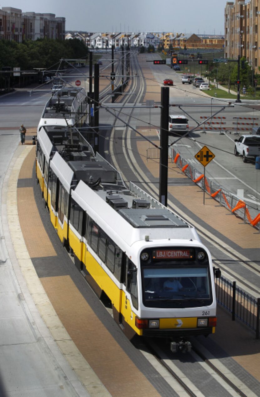 The new DART Orange Line train crosses O'Connor Blvd as it approaches the Las Colinas Urban...