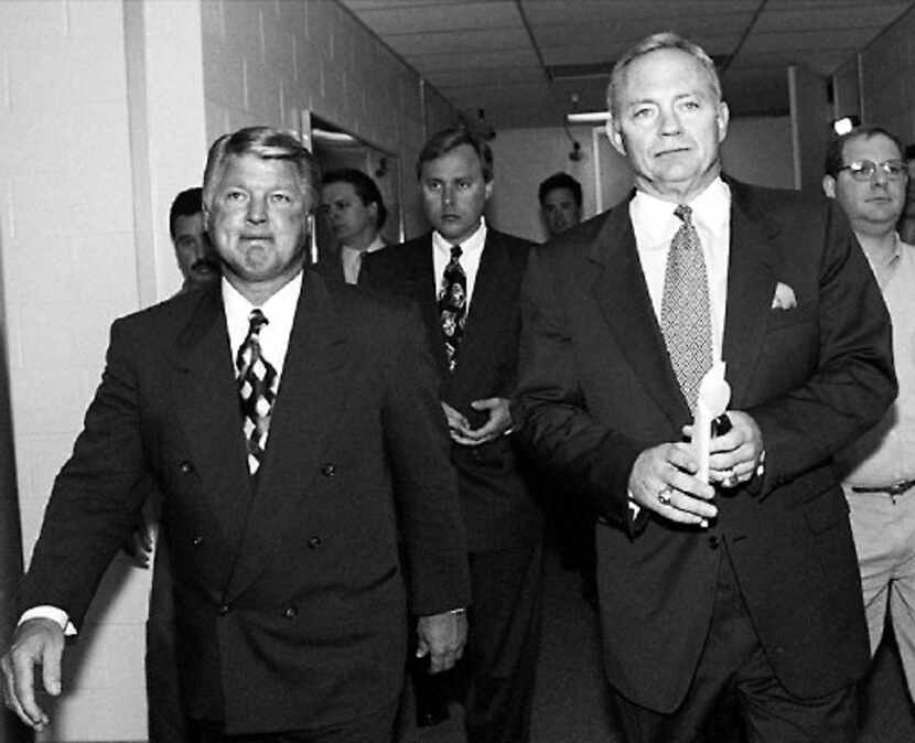Jimmy Johnson (left) walks past the Dallas Cowboys locker room with Jerry  Jones on their...