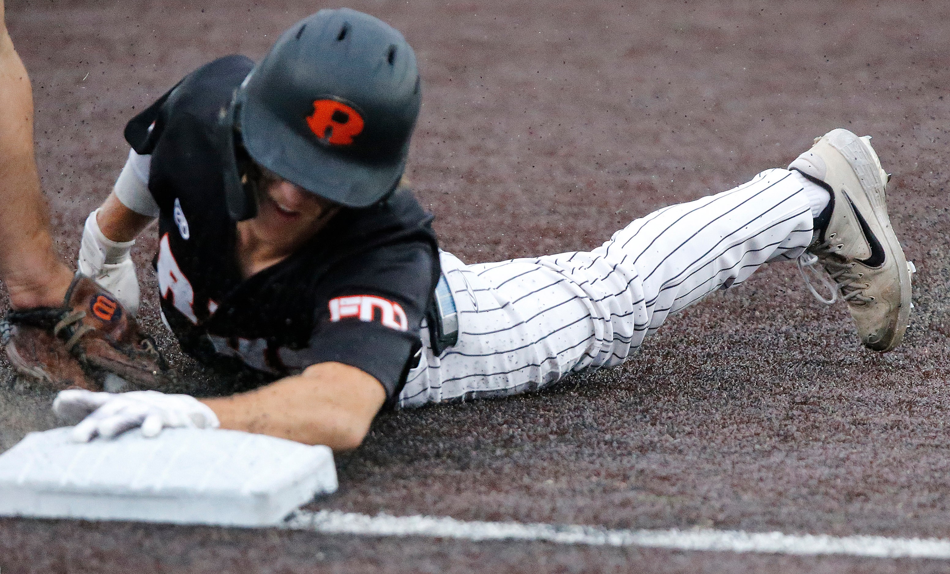 Rockwall shortstop Brayden Randle (2) was called out at third on the tag in the first inning...