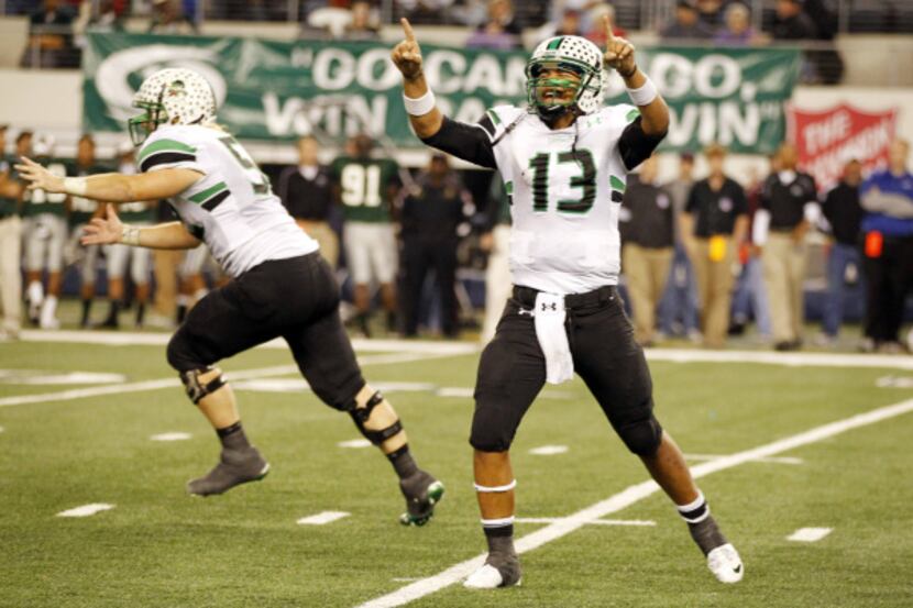 Quarterback Kenny Hill points to the sky as Southlake Carroll celebrates its state...
