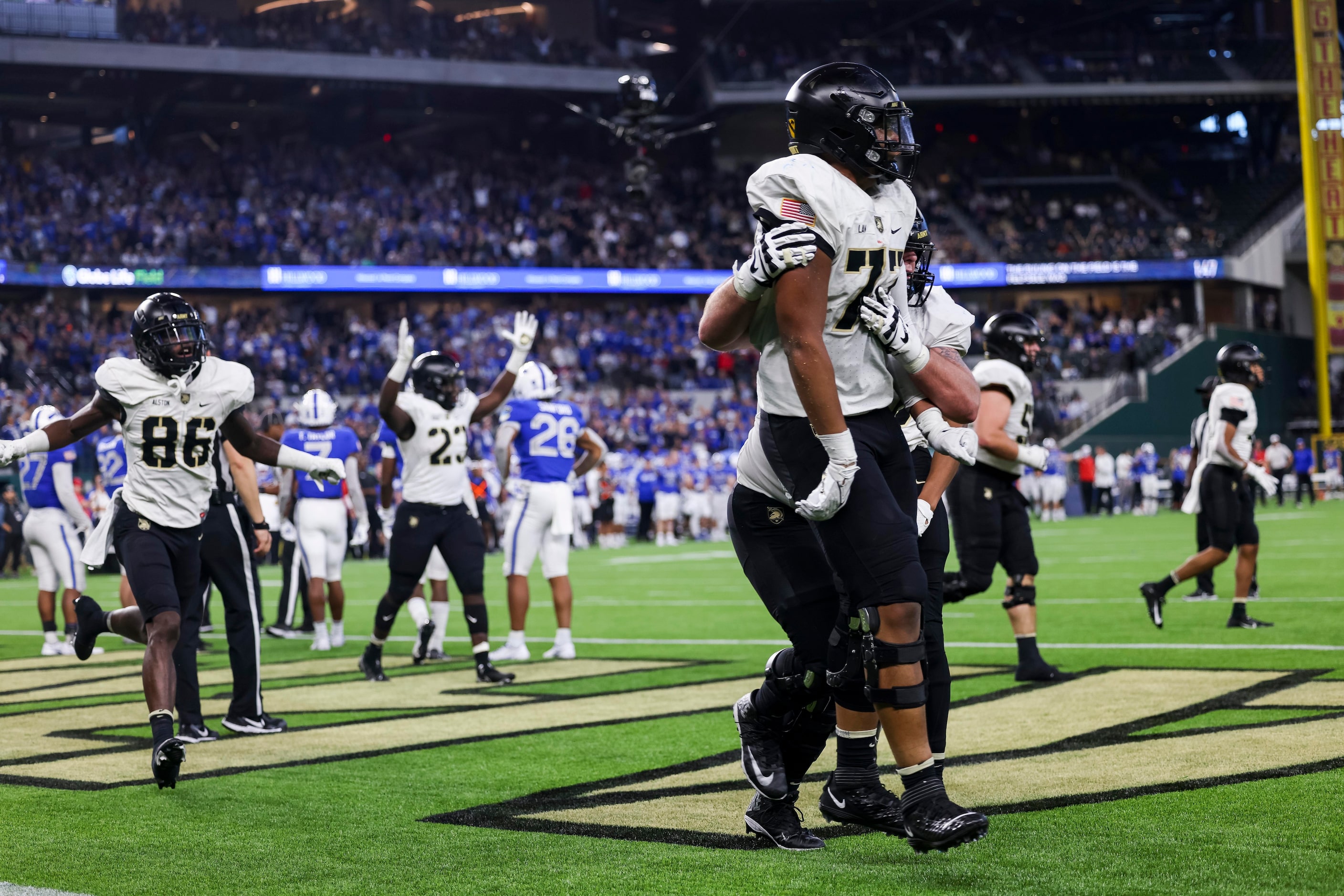 Army Black Knights offensive lineman Jordyn Law (77) and teammates celebrate a touchdown...