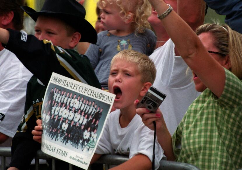 Dallas Stars fans cheer on their Stanley Cup champions in a victory parade Monday afternoon...