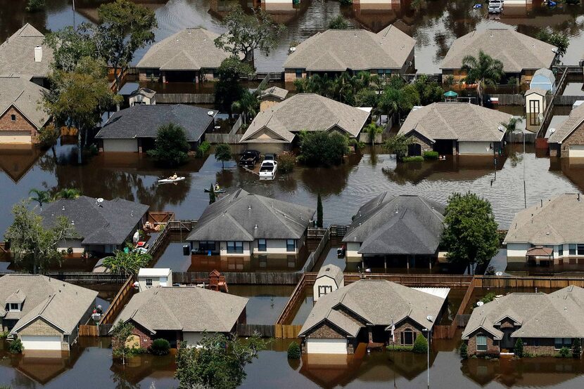 In this Sept. 1, 2017, photo, homes are surrounded by water from the flooded Brazos River in...