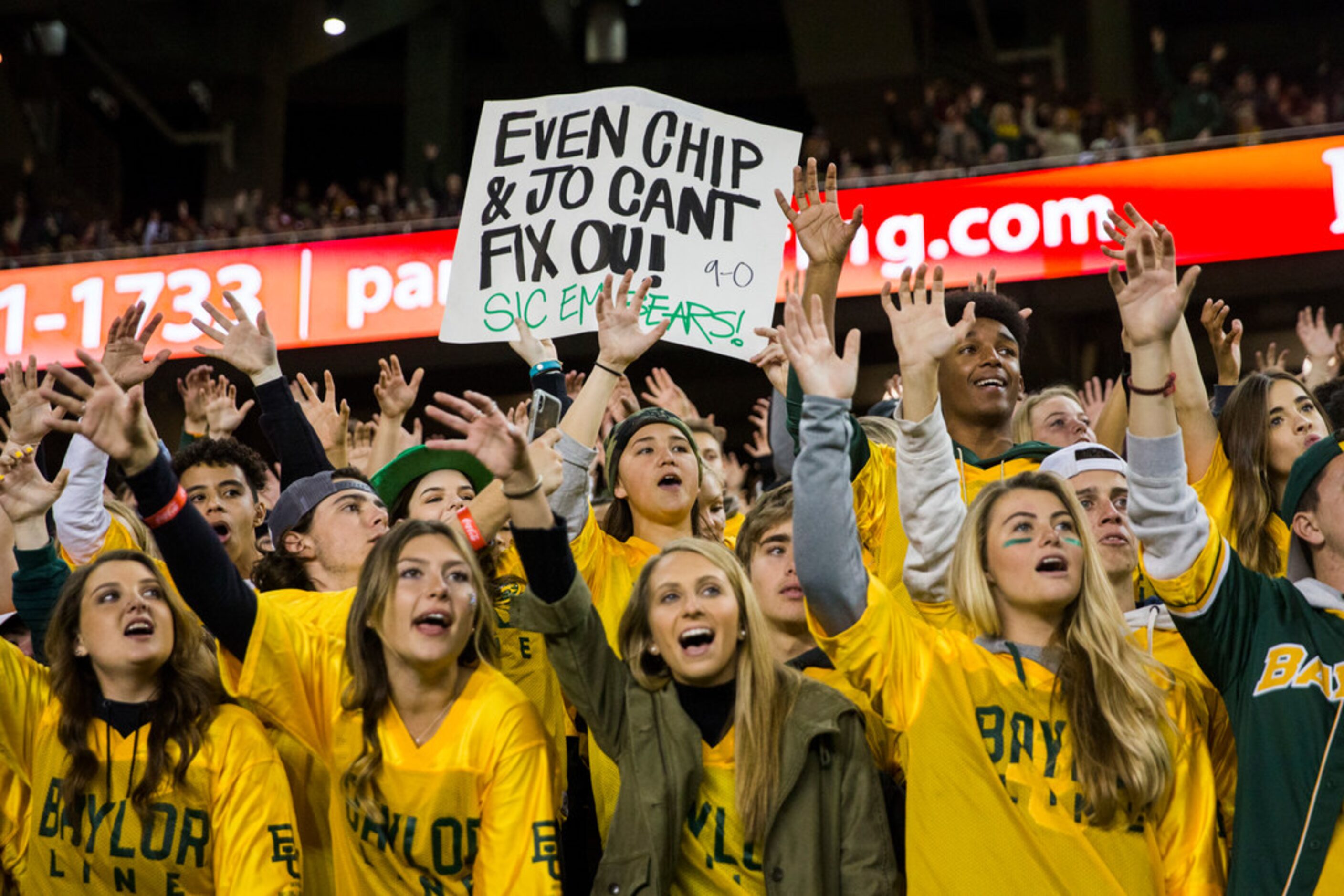 Baylor Bears fans cheer and hold up a sign during the first quarter of an NCAA football game...