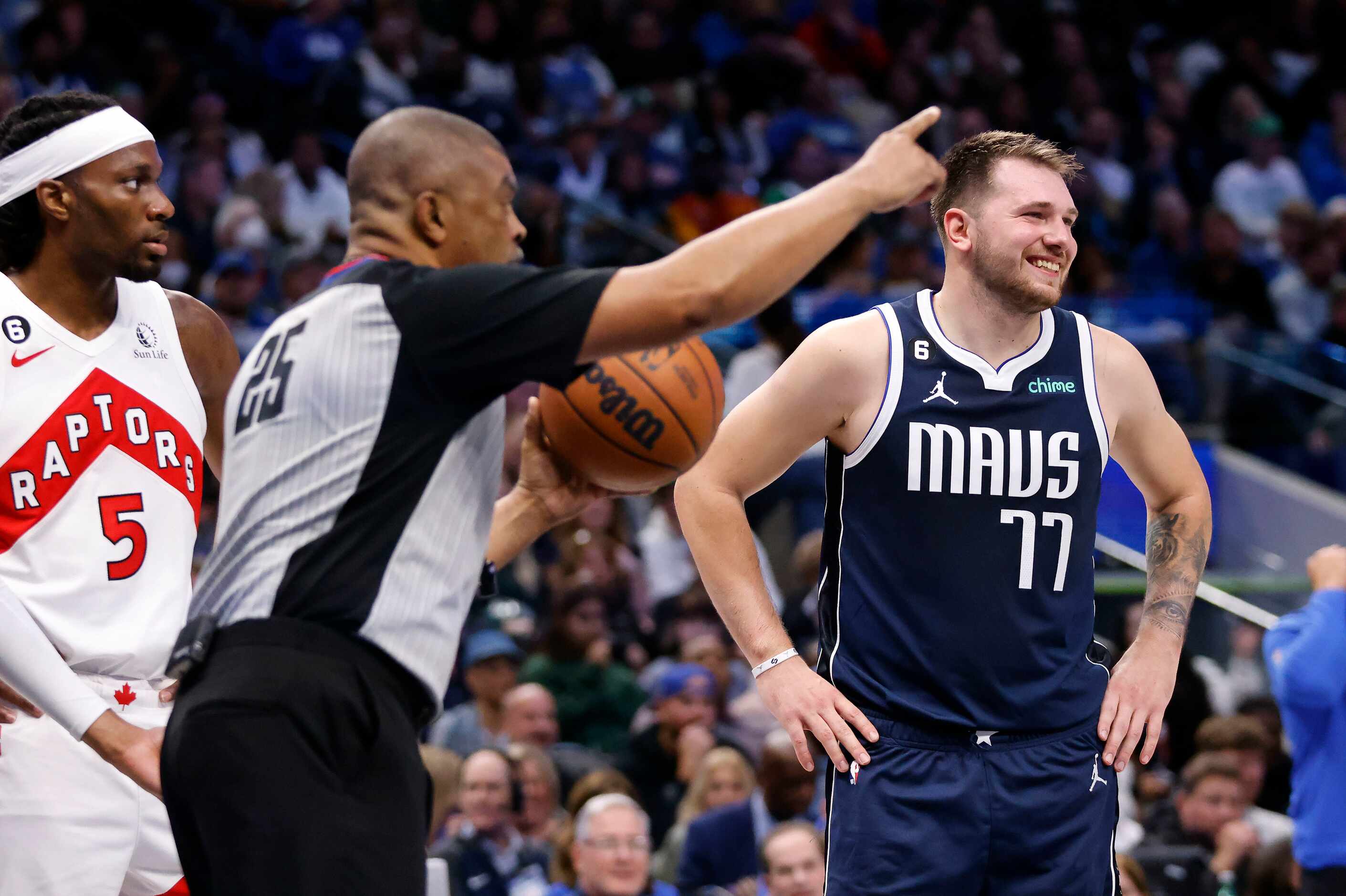 Dallas Mavericks guard Luka Doncic (77) laughs after another foul was called on the...