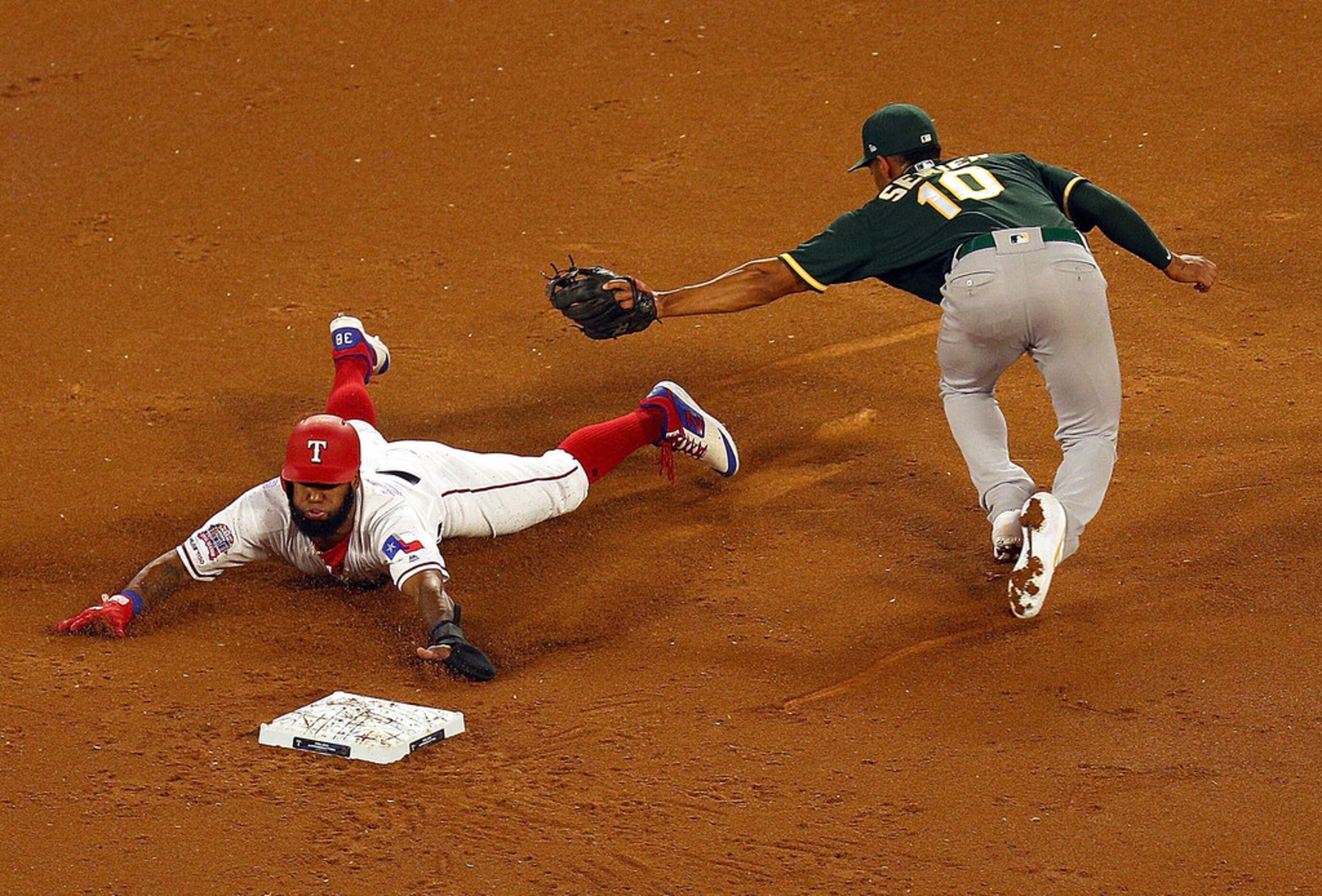 ARLINGTON, TEXAS - SEPTEMBER 13: Danny Santana #38 of the Texas Rangers steals second ahead...