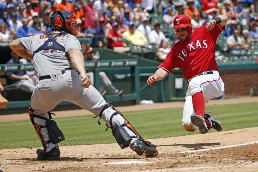 Texas Rangers catcher Bryan Holaday (8) scores in the third inning against Houston Astros...