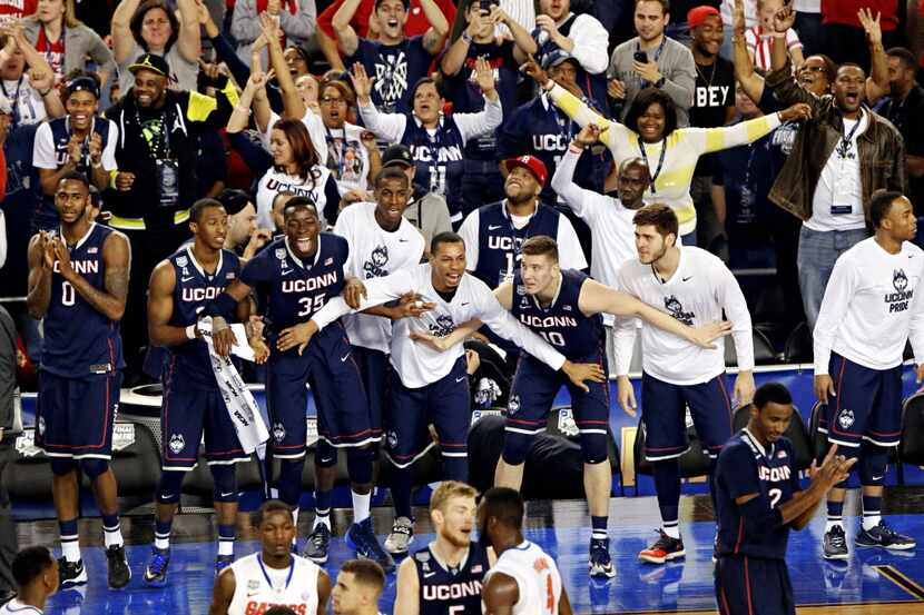 The Connecticut Huskies bench erupts at their win during the second half of their NCAA Final...