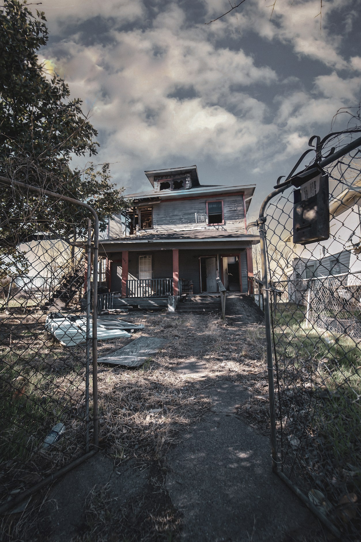 An abandoned home with shattered windows in Dallas's South Boulevard/Park Row neighborhood.