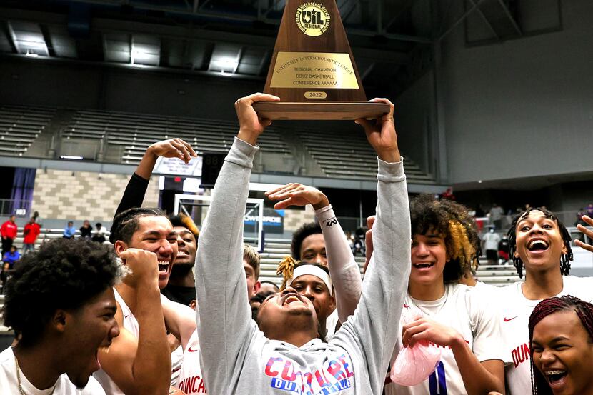 The Duncanville Panthers hold up their trophy after defeating Garland, 61-38 in the 6A UIL...