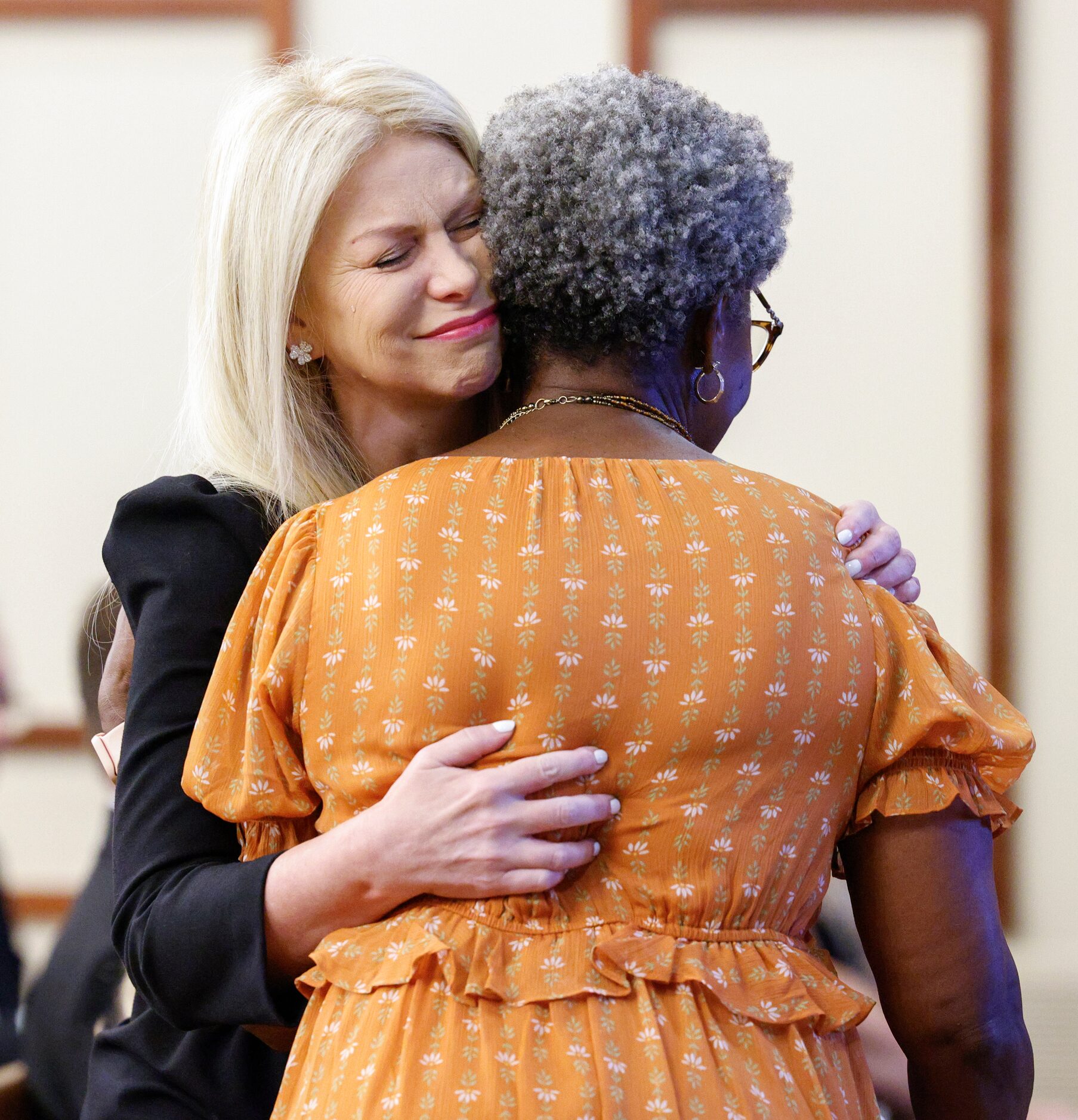 Sarah Dodd, David Kunkle’s wife (left), embraces his executive assistant and friend Deborah...