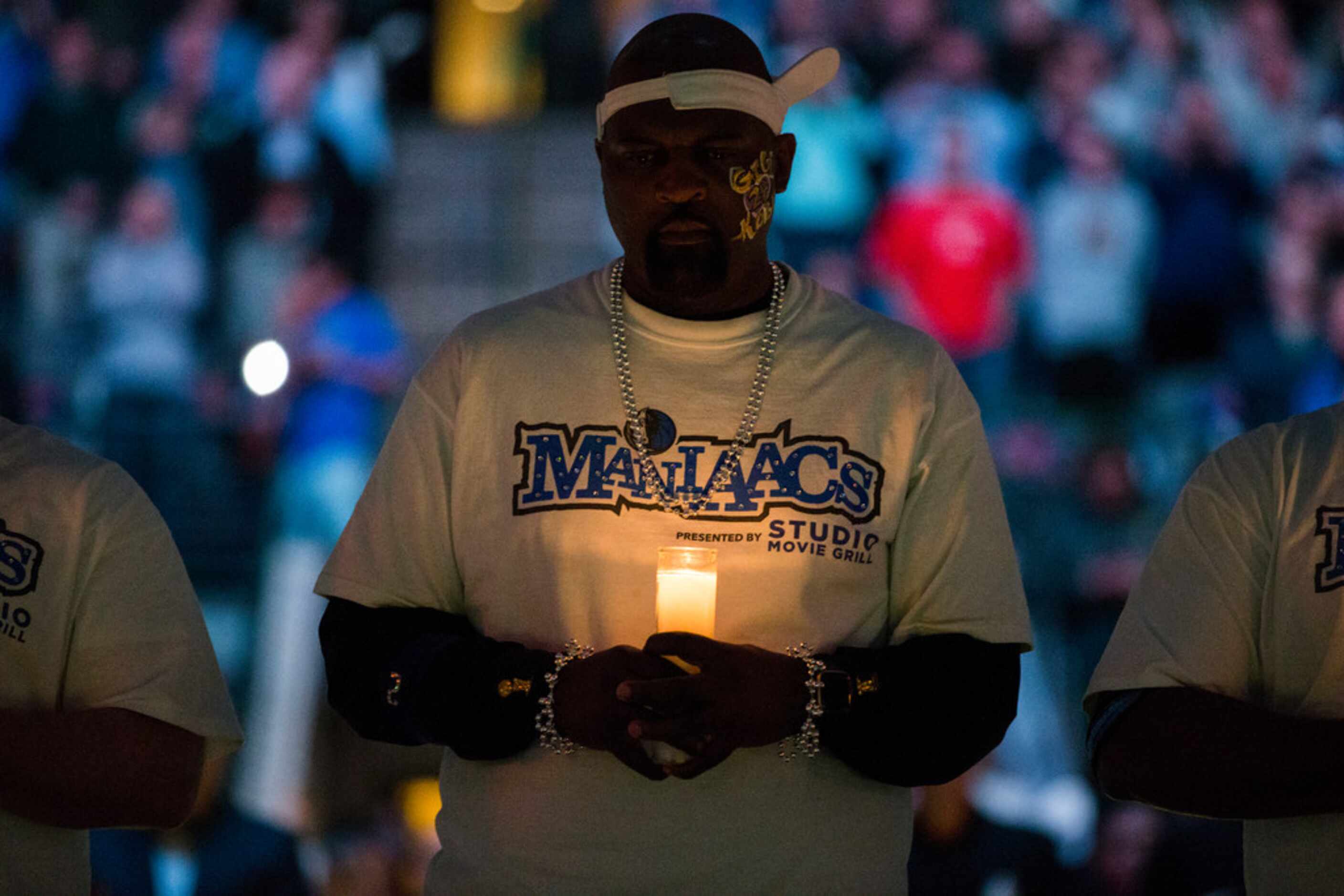 Mavs Maniacs hold candles during a tribute to former Los Angeles Laker Kobe Bryant and his...