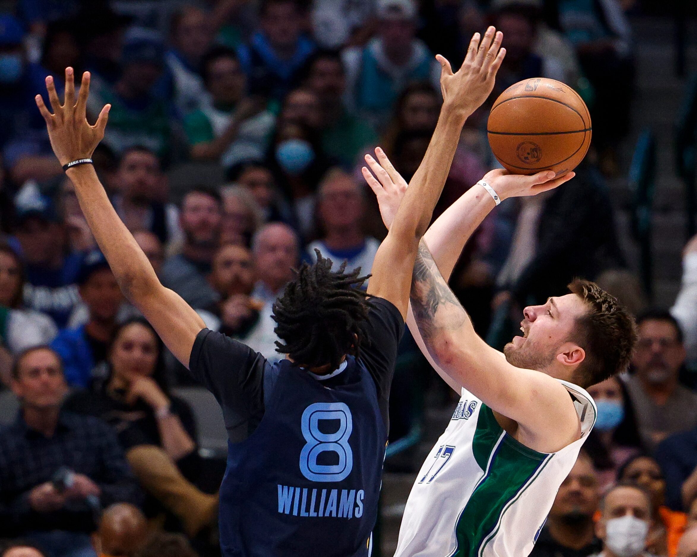 Dallas Mavericks guard Luka Doncic (77) is fouled as he attempts a shot by Memphis Grizzlies...