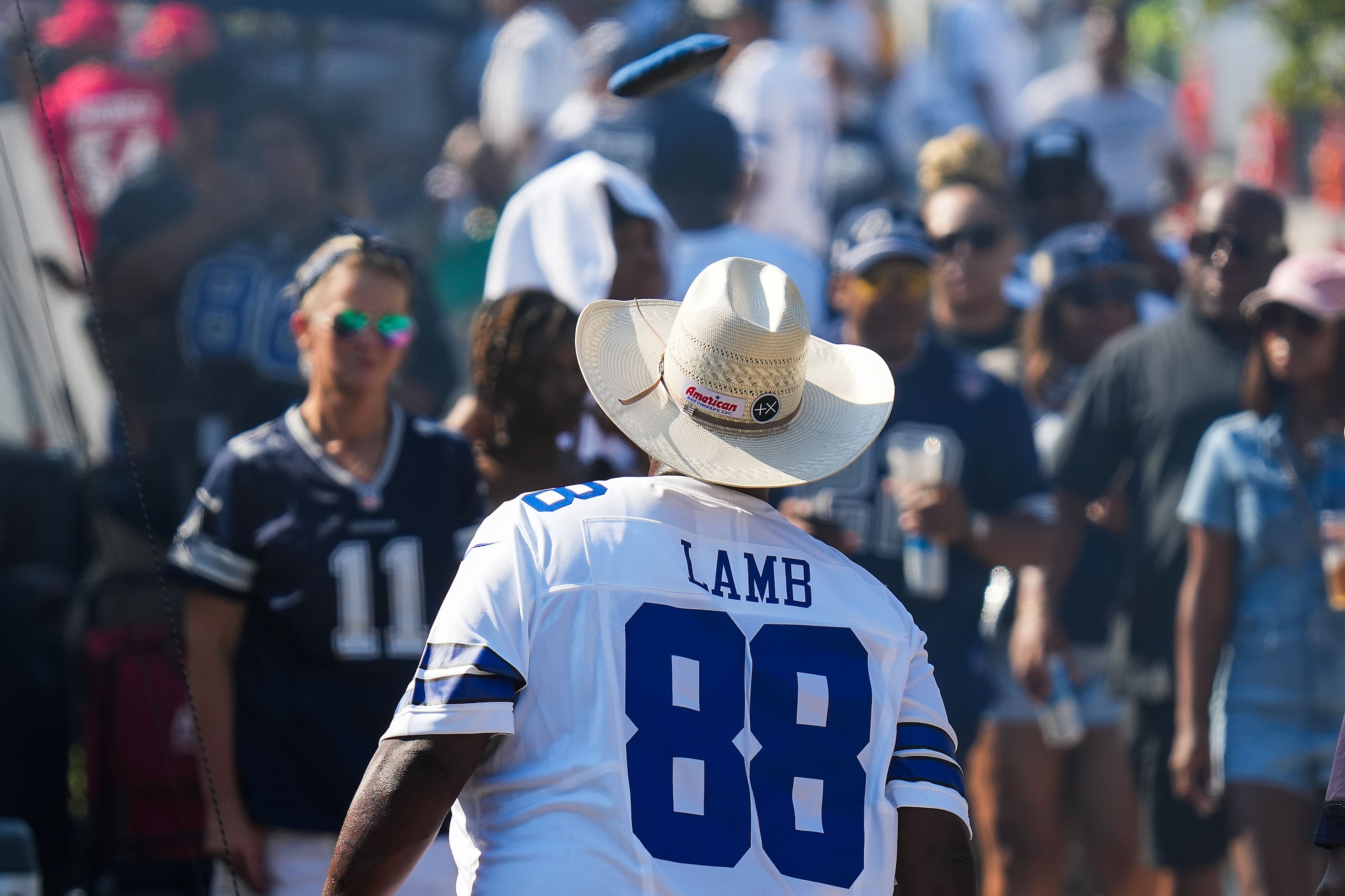 Fans play cornhole while tailgating before an NFL football game between the Dallas Cowboys...