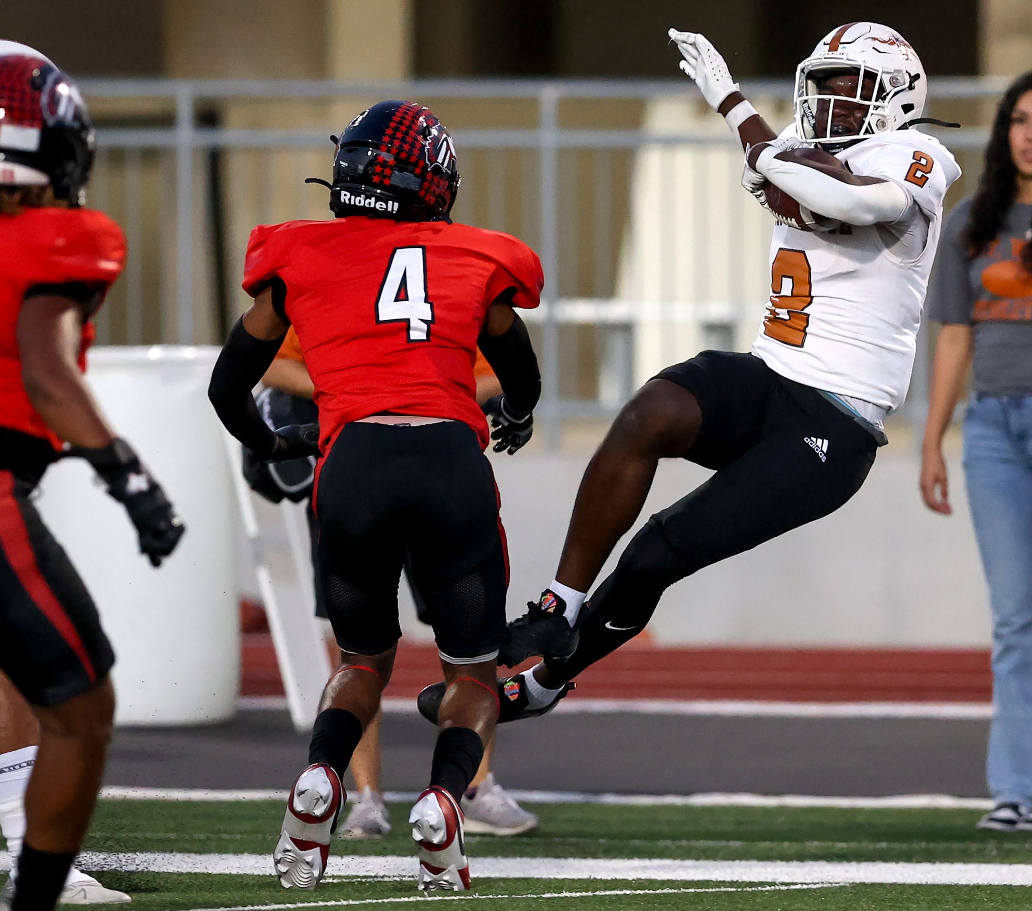 W.T. White running back Ben Ebeke (2) gets hit hard by Creekview defensive back Isaiah...