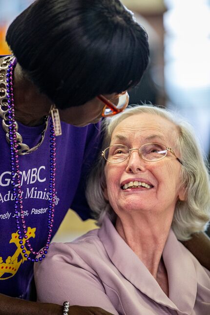 Greater Community Missionary Baptist Church member Carrie Ward (left) visits with Janice...