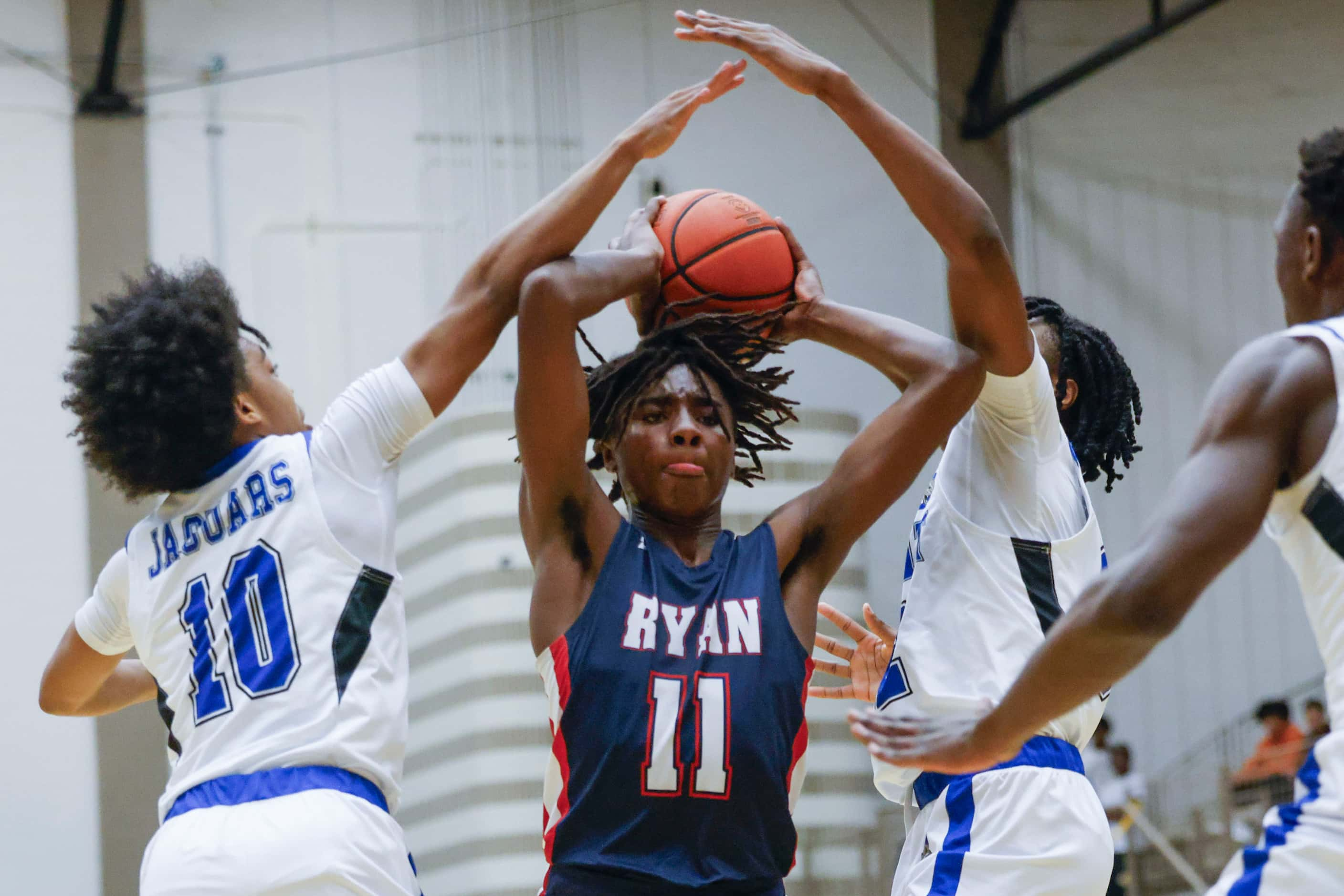 Mansfield Summit’s Jesse Warner (left) and Quinton Owens-Ross (right) defend against Denton...