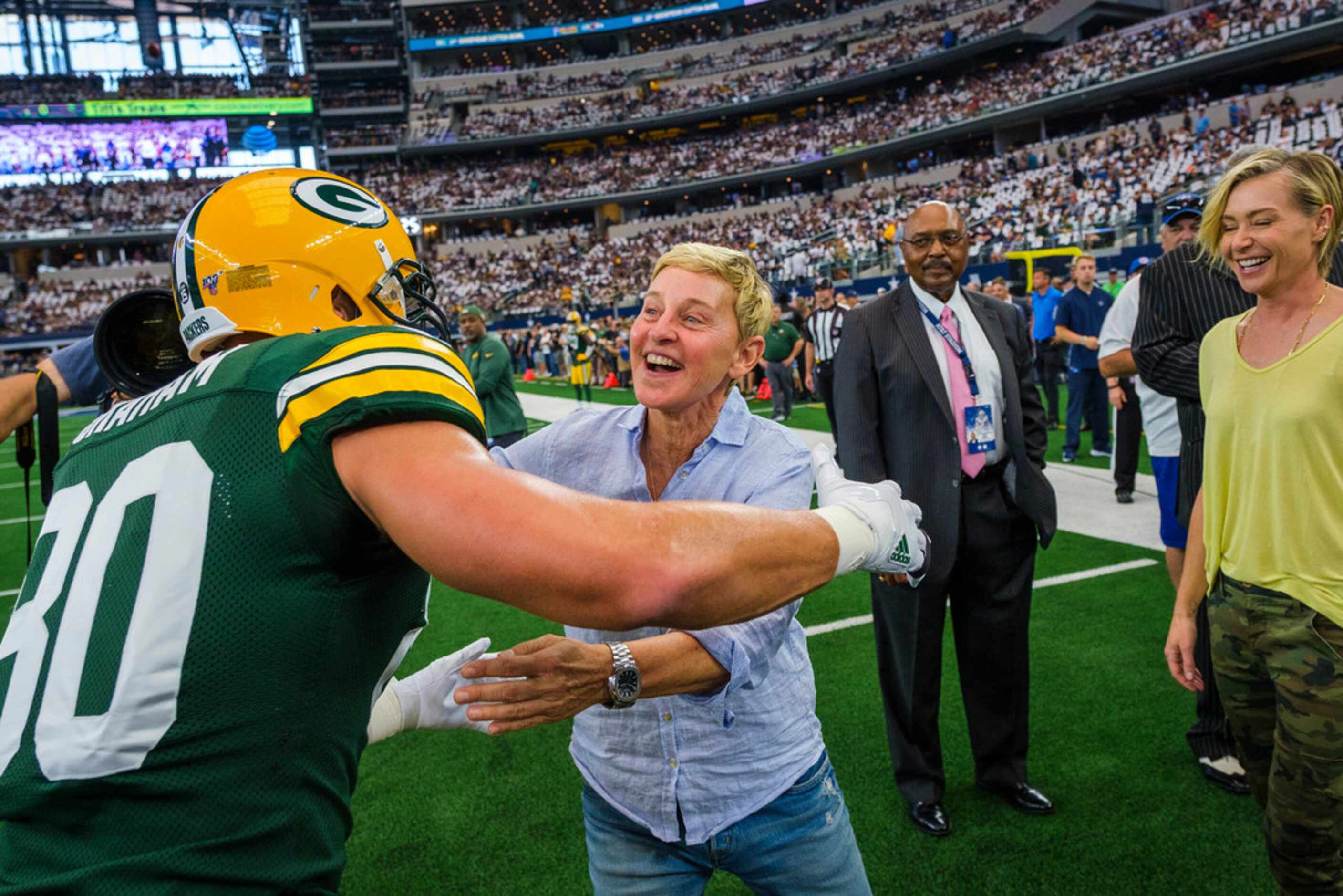 Ellen DeGeneres hugs Green Bay Packers tight end Jimmy Graham before an NFL football game...