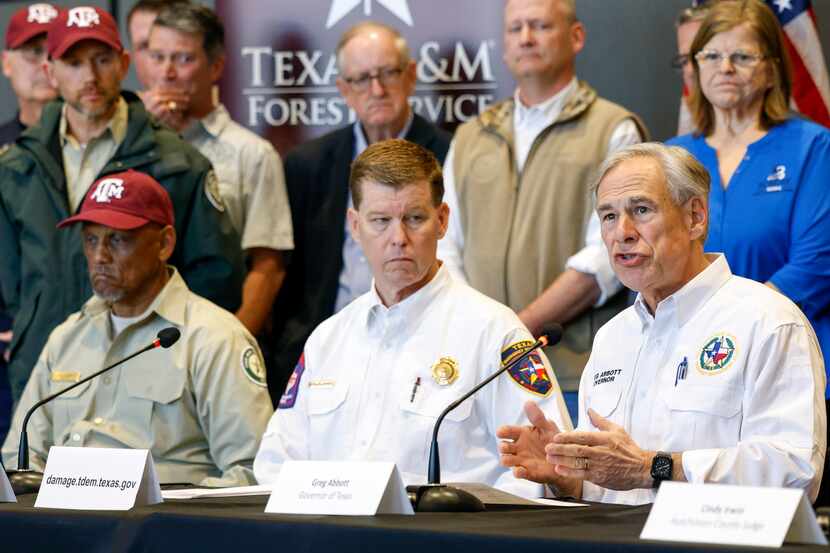 Texas Gov. Greg Abbott (right) speaks during a news conference about the panhandle wildfires...