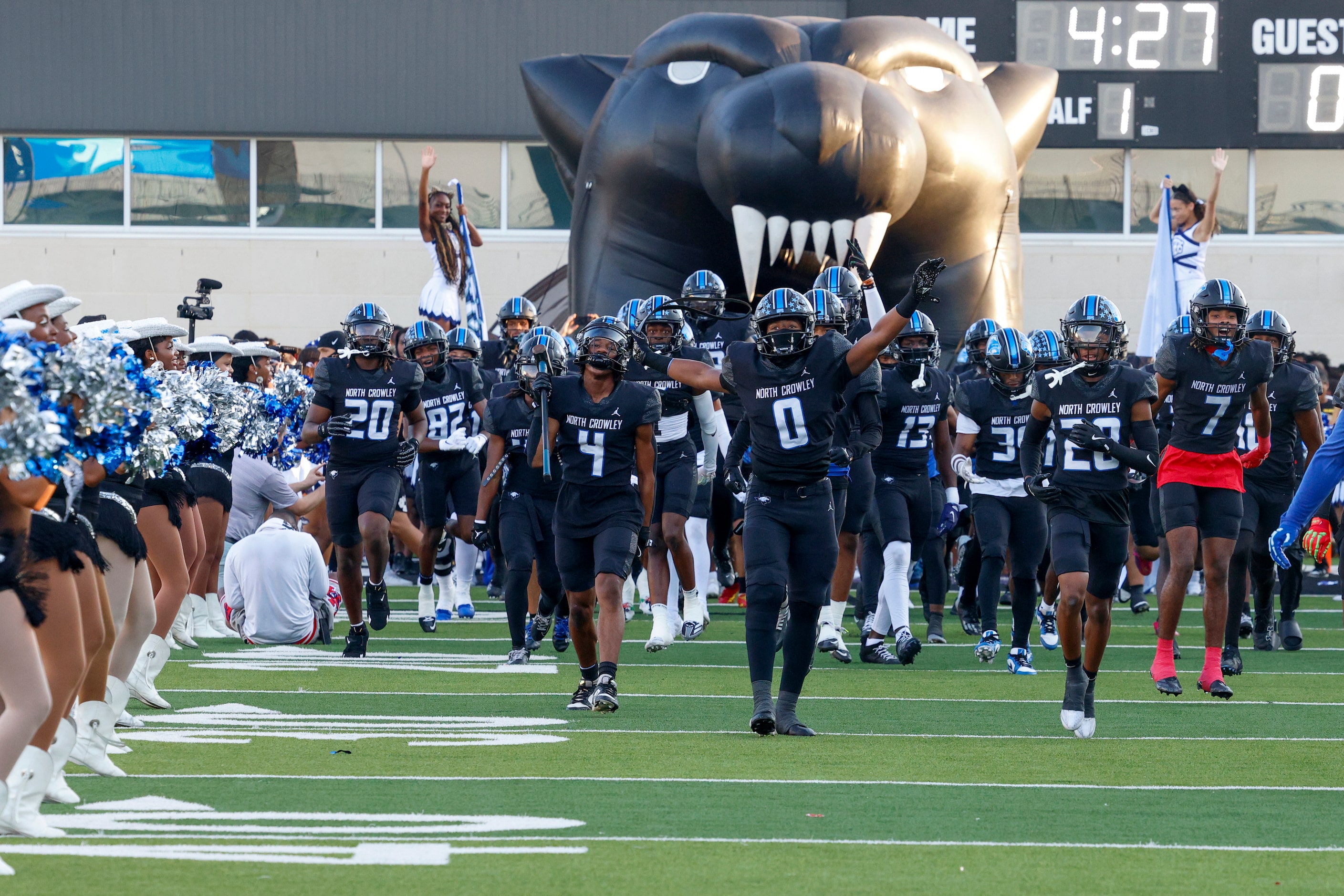 The North Crowley team takes the field before the first half of a non-district high school...