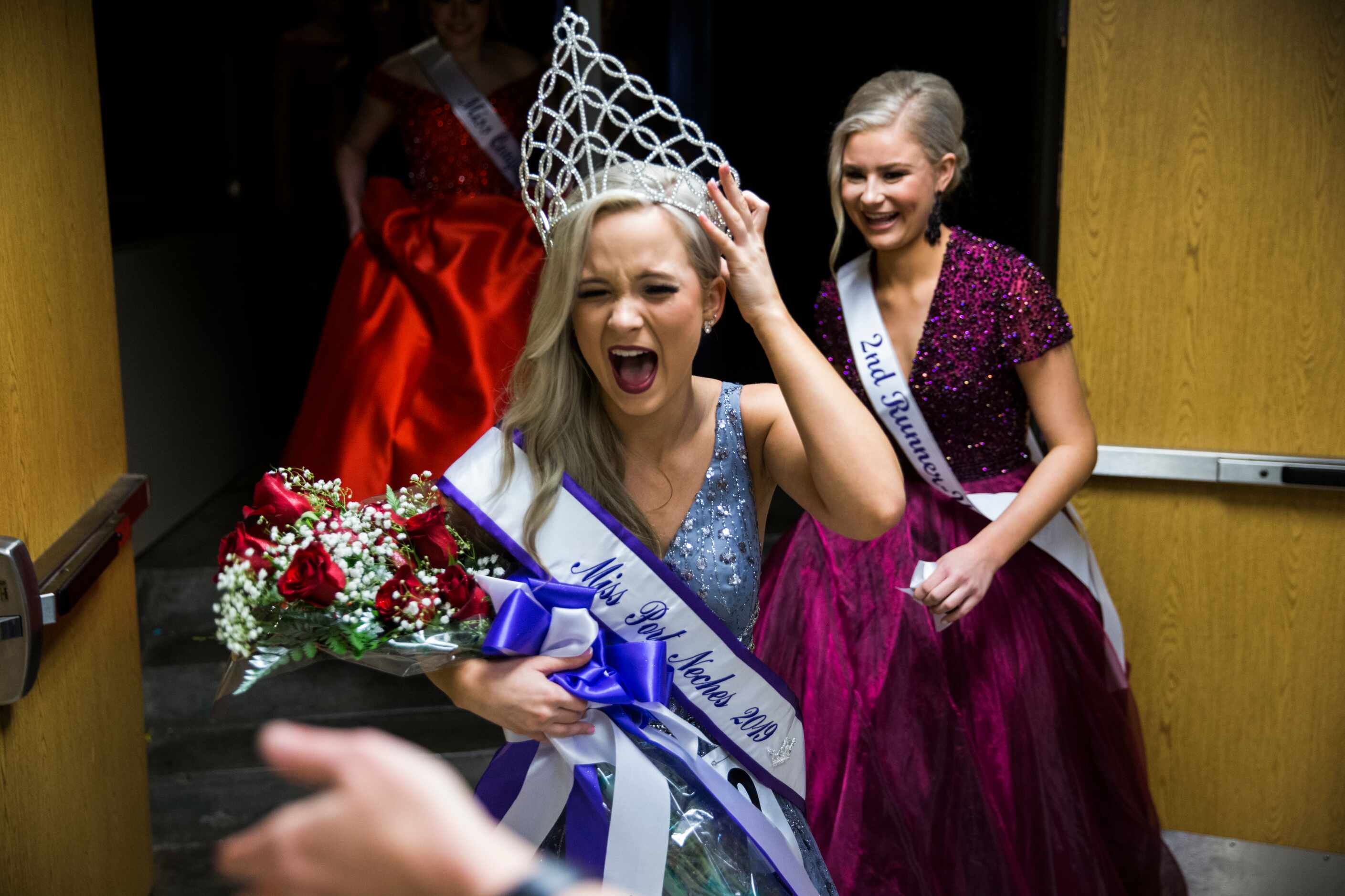 Chloe Cannon holds onto her tiara as she leaves the stage after being named Miss Port Neches...