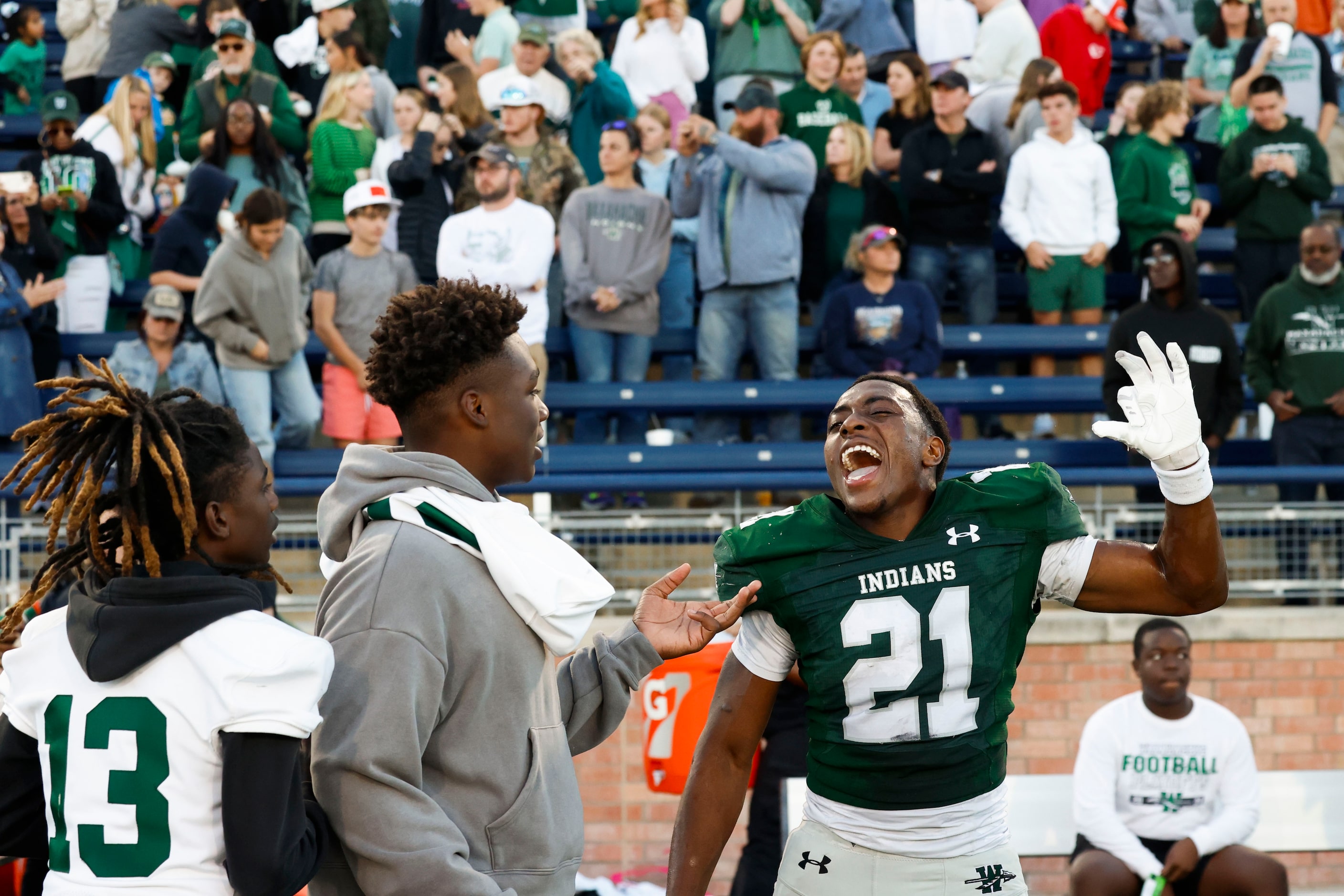 Waxahachie high’s D’Marion Cooper (21) celebrates following their win against North Forney...