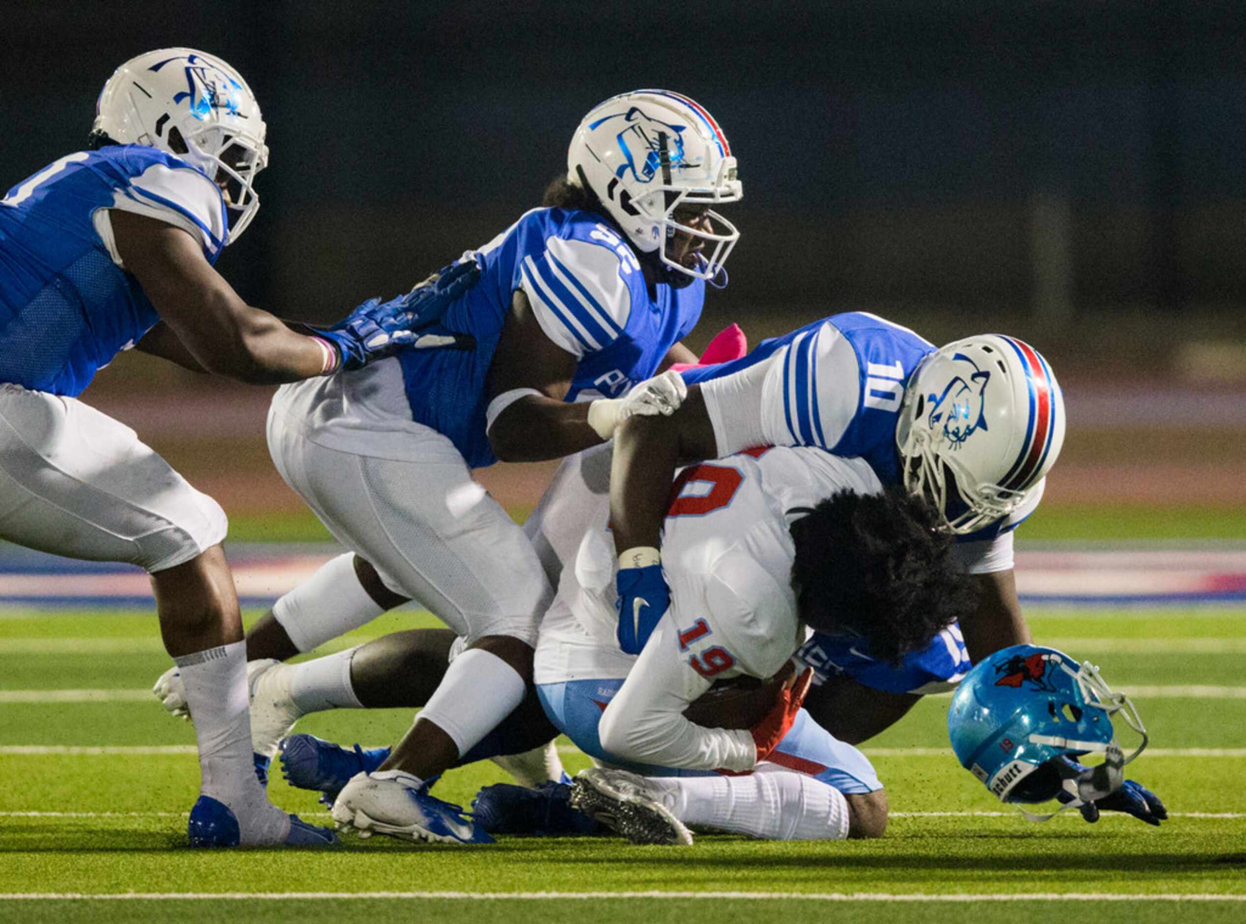 Skyline wide receiver Arabia Bradford (19) is tackled by Duncanville defensive lineman Kevon...