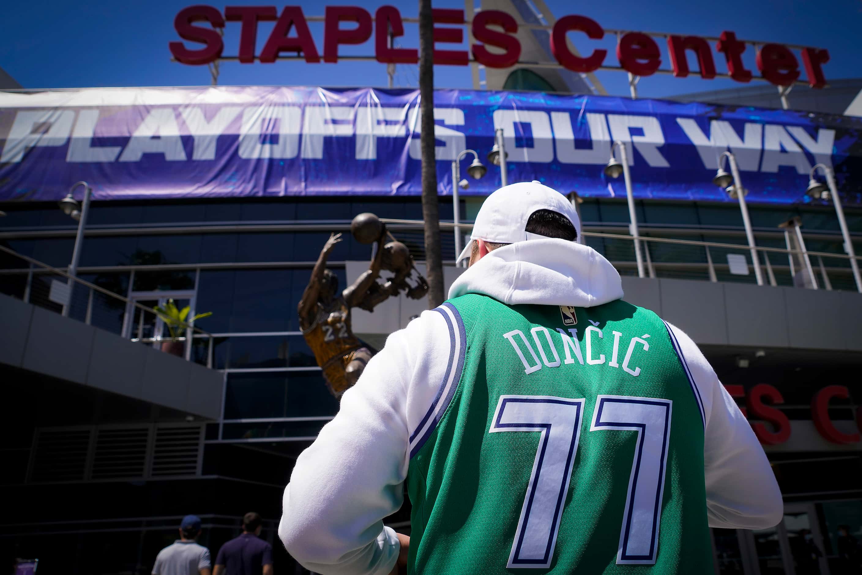 Dallas Mavericks fans head to the arena before Game 7 of an NBA playoff basketball series...