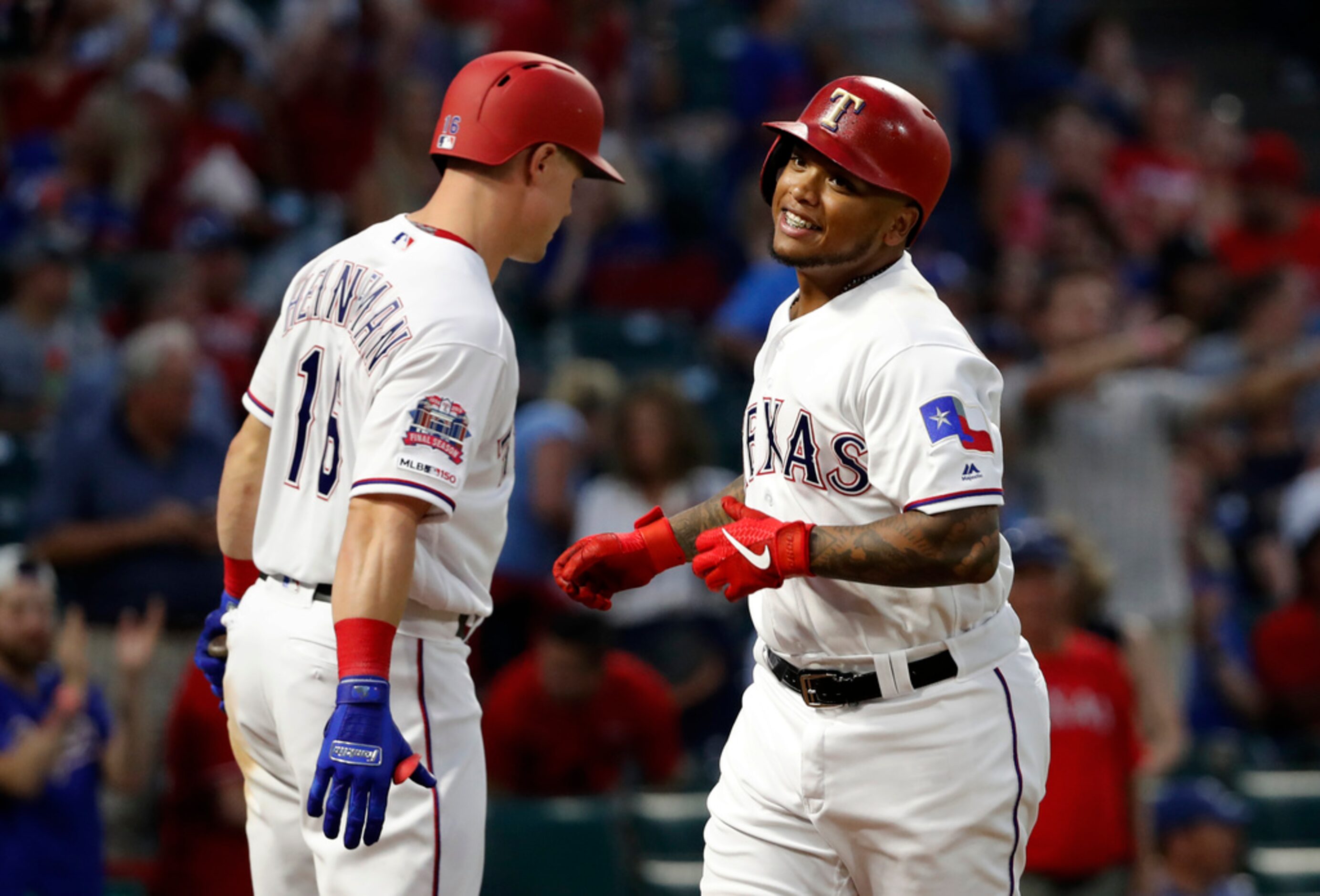 Texas Rangers' Scott Heineman, left, and Willie Calhoun, right, celebrate Calhoun's solo...