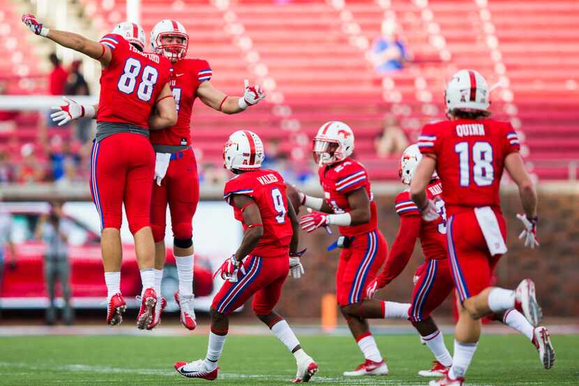 Southern Methodist Mustangs celebrate after safety Delano Robinson (24) recovered a fumble...