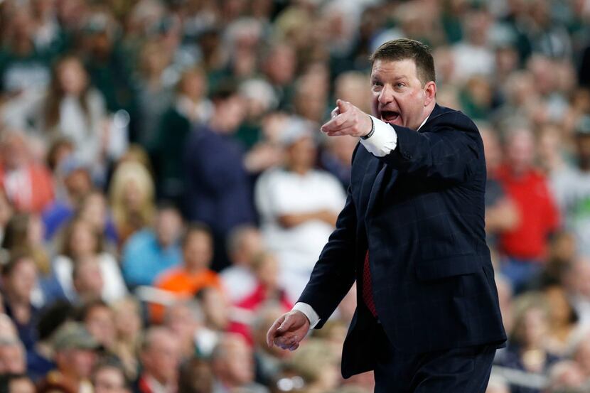 Texas Tech Red Raiders head coach Chris Beard communicates to one of his players during the...