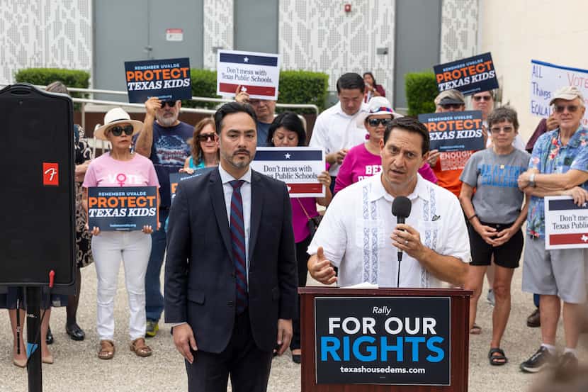 With U.S. Rep. Joaquin Castro next to him, state Rep. Trey Martinez Fischer speaks during a...