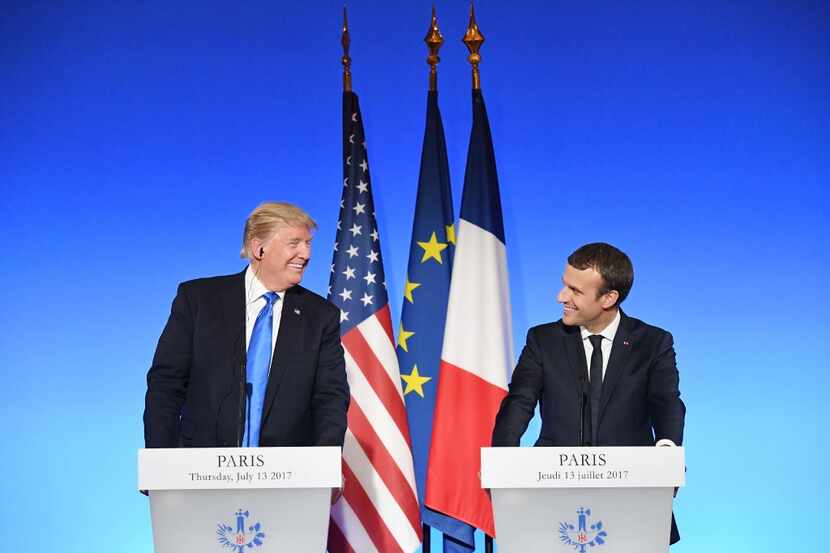 US President Donald Trump (L) and French President Emmanuel Macron (R) smile during a joint...