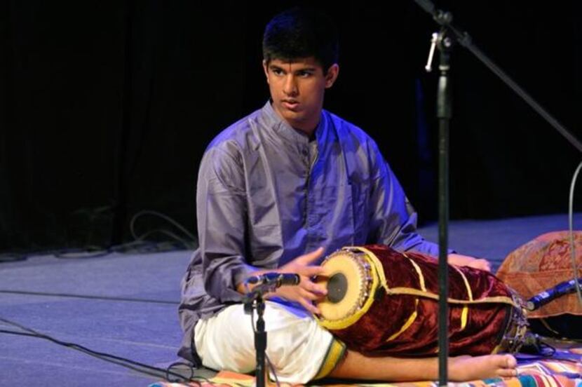 
Appaji plays a traditional Indian drum, the mridangam, during a performance at Plano’s...