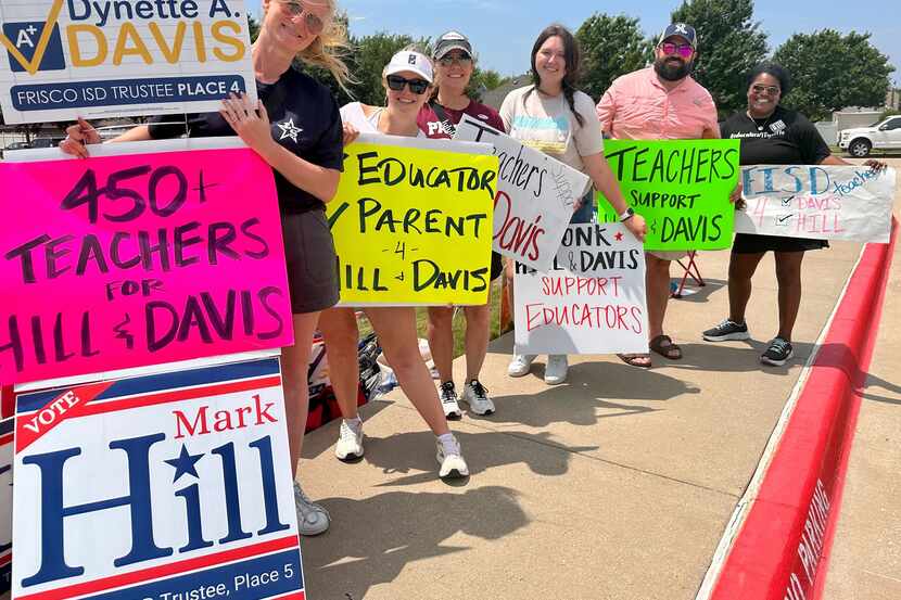 Voters show their support for Frisco ISD candidates Mark Hill and Dynette Davis at Frisco...