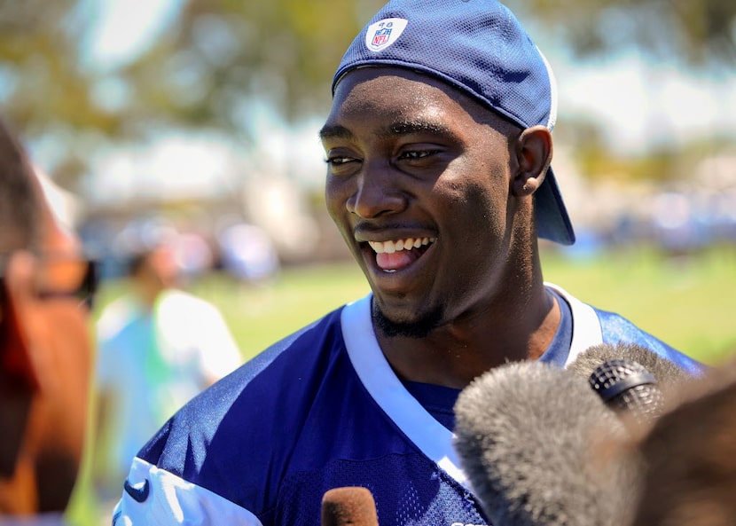 Dallas Cowboys defensive end DeMarcus Lawrence talks with the media during NFL football...