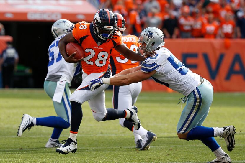 Denver Broncos running back Jamaal Charles (28) pushes Dallas Cowboys middle linebacker Sean...