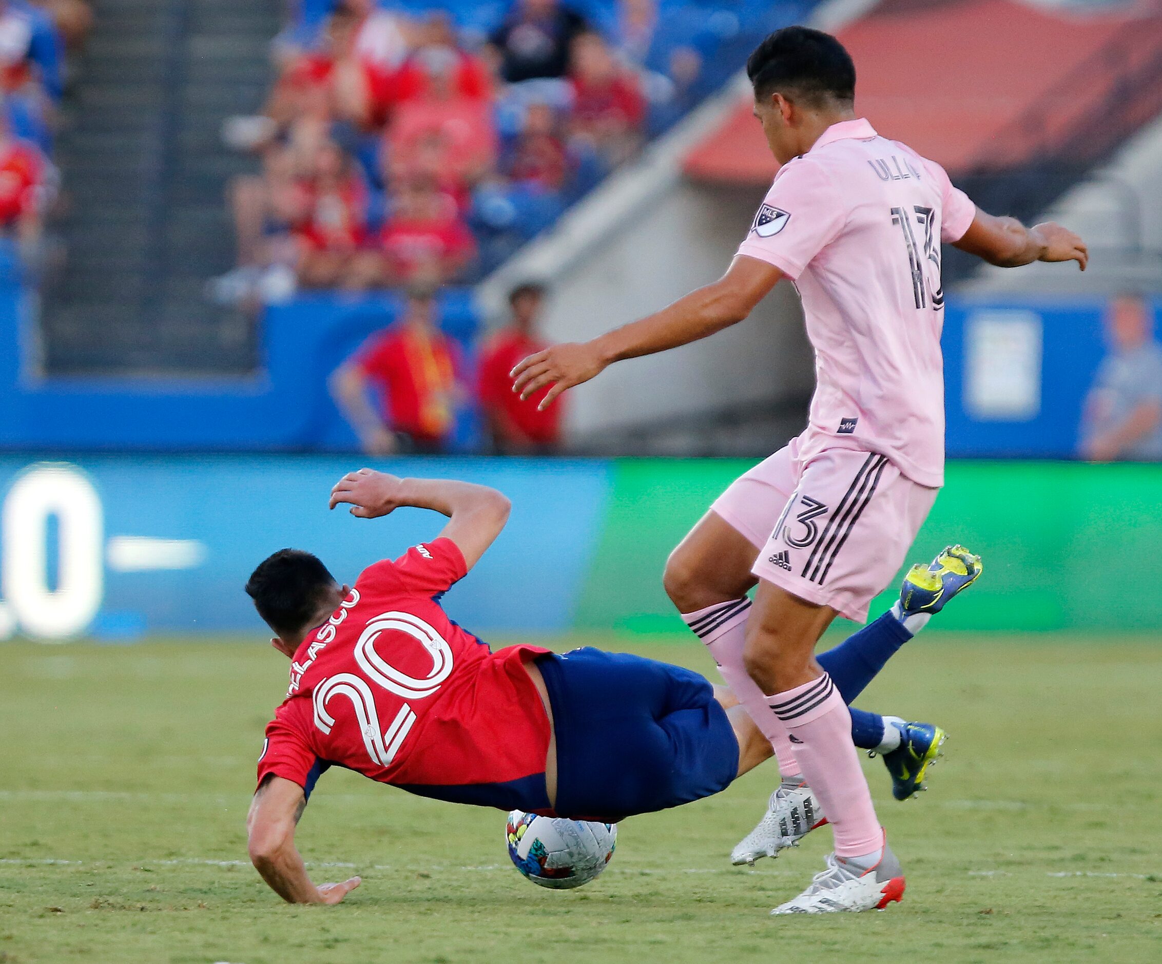 FC Dallas forward Alan Velasco (20) is sent to the ground ground by Inter Miami midfielder...