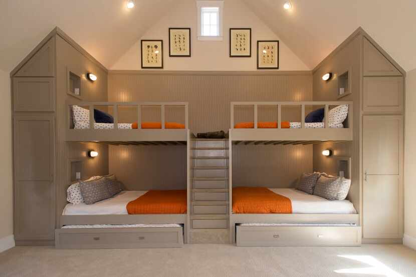 Built-in steps with drawer storage divide full-over-queen bunk beds designed by John Boyd....